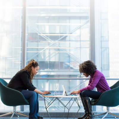 Women working at table on laptops