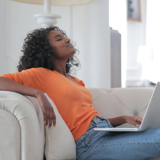 Woman relaxing on couch with laptop