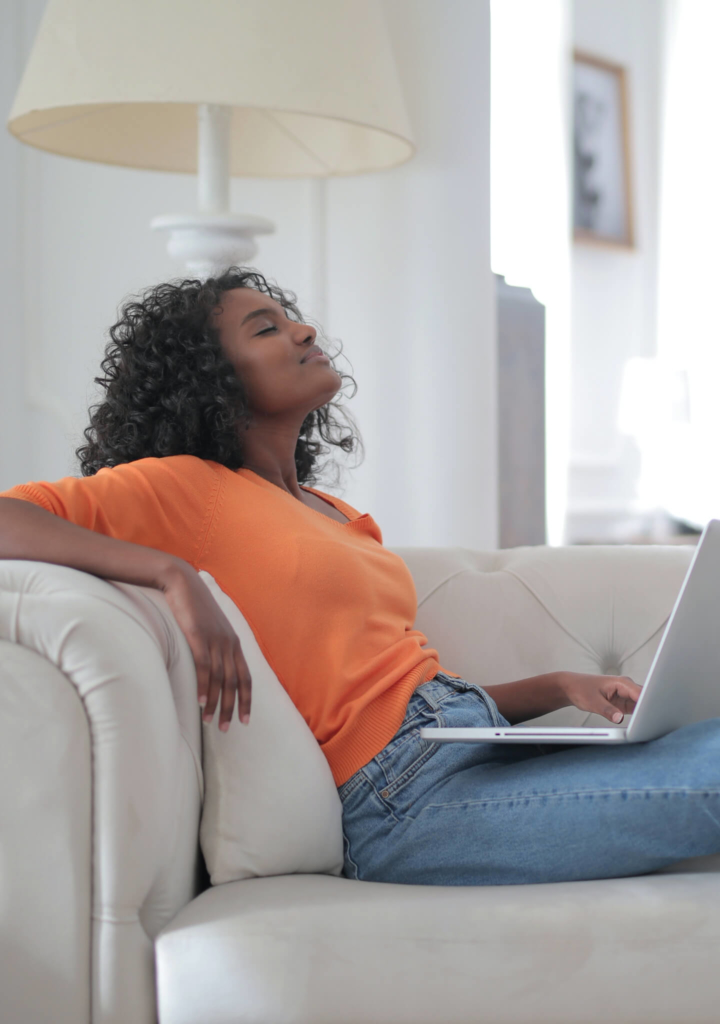 Woman relaxing on couch with laptop