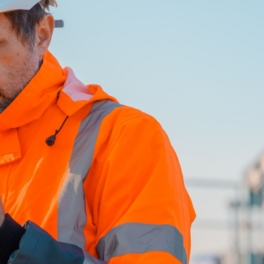 Oil rig worker looking at iphone
